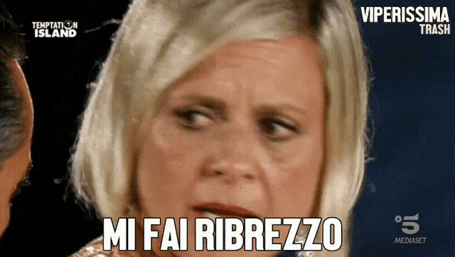 a woman says " mi fai ribrezzo " in front of a man