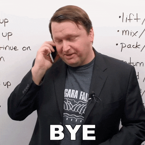 a man in a suit is talking on a cell phone while wearing a shirt with the word gara fall on it