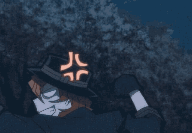 a cartoon character wearing a hat with an angry face on it is laying on the ground .