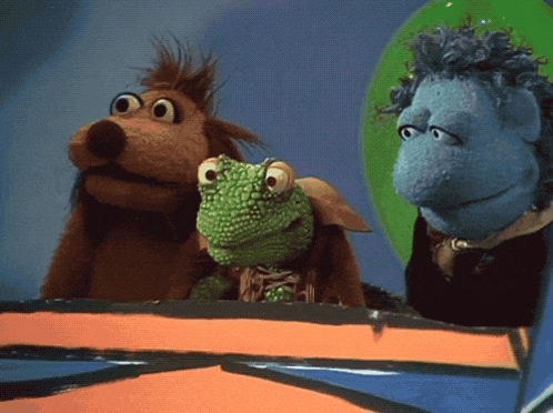 a group of stuffed animals including a dog and a frog