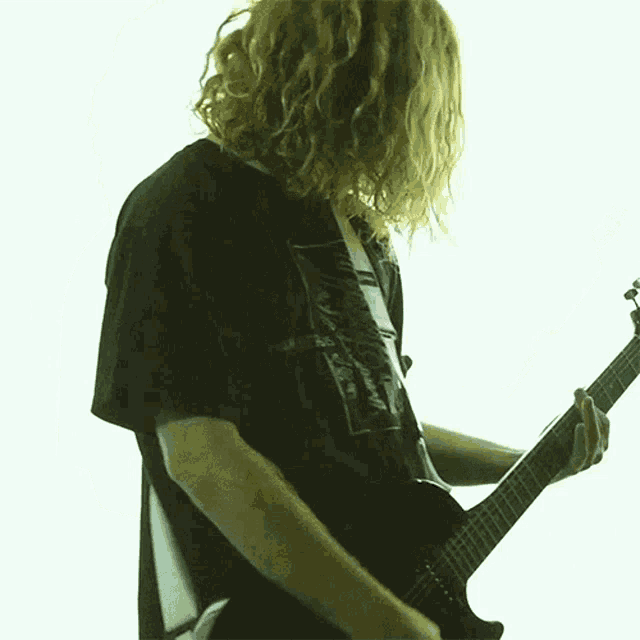 a man playing a guitar with a shirt that says chamber 6