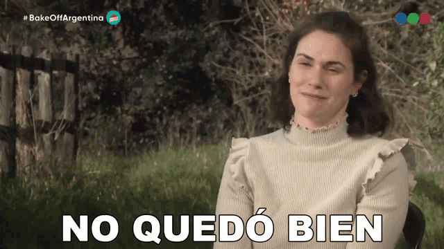a woman says no quedo bien while sitting in the grass