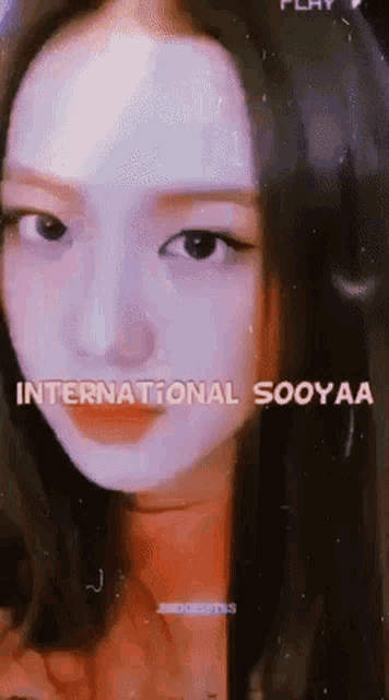 a close up of a woman 's face with the words international sooyaa written above her