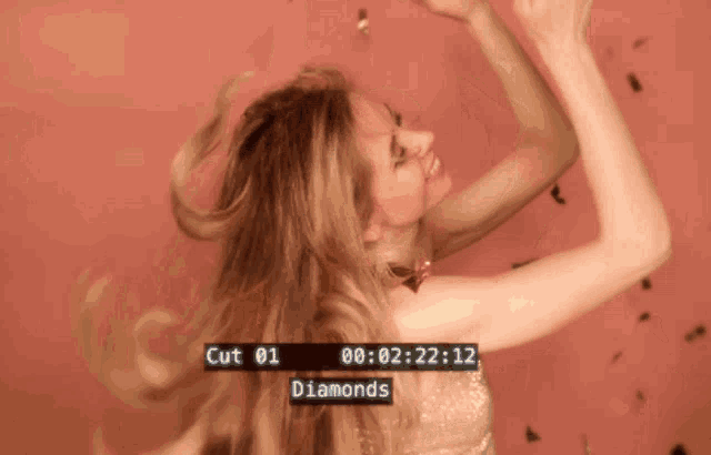 a woman is dancing in front of a screen that says cut 01