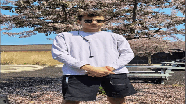 a young man wearing sunglasses and a sweatshirt that says ' rm ' on it