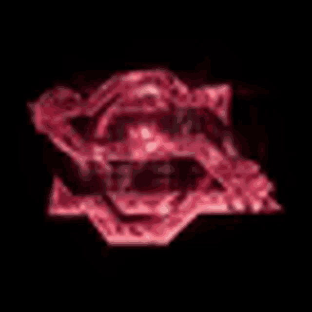 a close up of a red logo on a black background