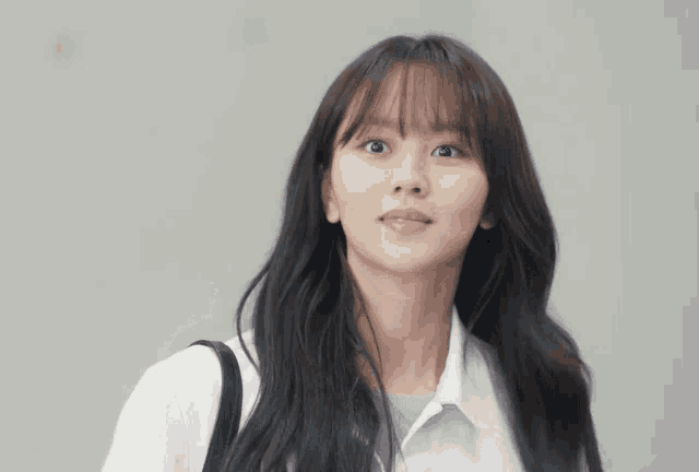 a woman is smiling and holding her hair with the word fighting written below her