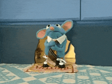 a blue mouse is sitting on a welcome rug