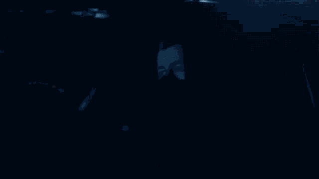 a car is driving down a dark street at night with a lot of lights on .