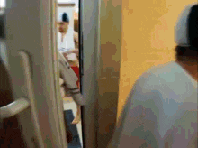 a blurry picture of a person walking through a doorway .