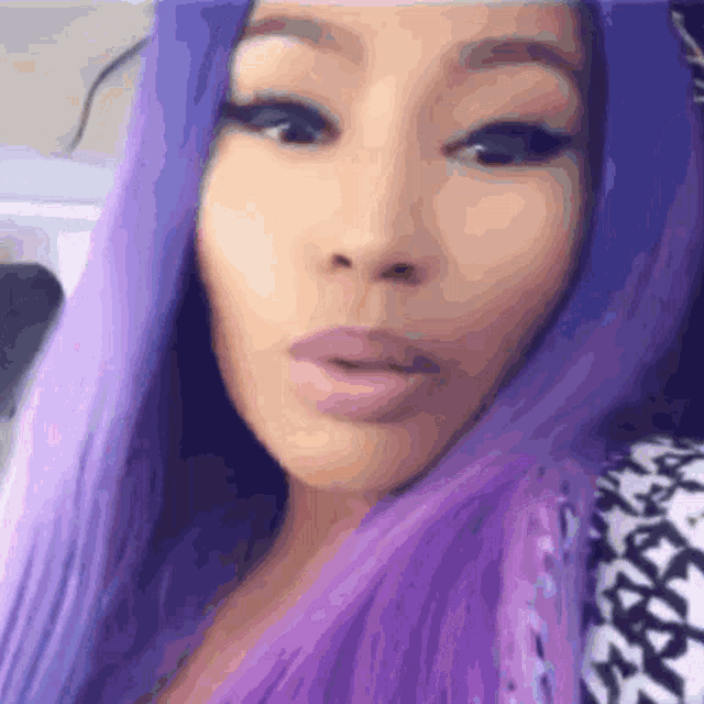a woman with purple hair takes a selfie