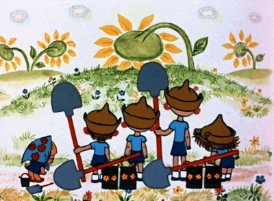 a group of children holding shovels in a field