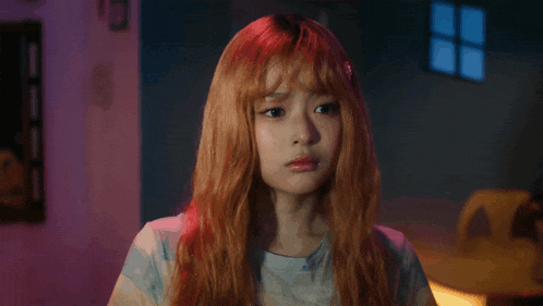 a girl with red hair making a sad face