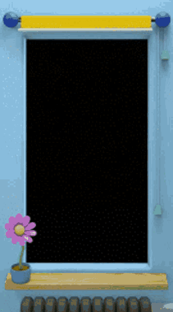 a picture frame with a flower on a shelf