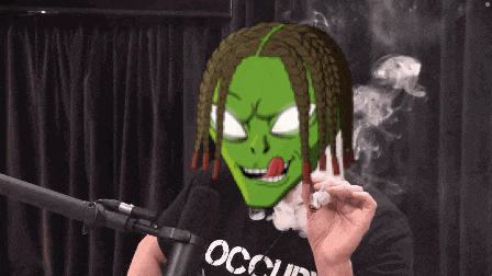 a man wearing a black shirt with the word occupy on it smoking a cigarette
