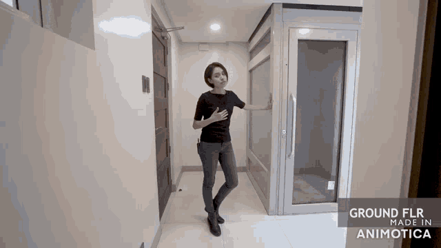 a woman standing in a hallway with the words ground flr made in animotica