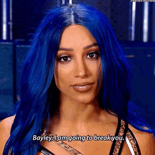 a woman with blue hair says bayley i am going to break you ..
