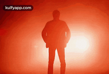 a silhouette of a man standing in front of a red background with the website kulfyapp.com in the upper right corner