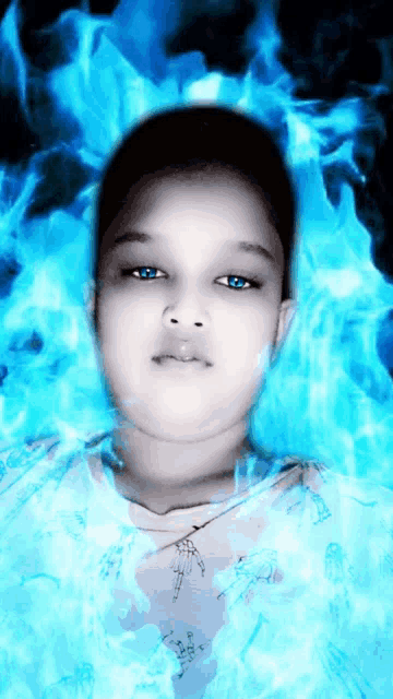 a boy with blue eyes is surrounded by blue flames and smoke