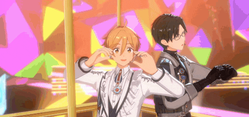 a couple of anime characters standing next to each other on a stage .