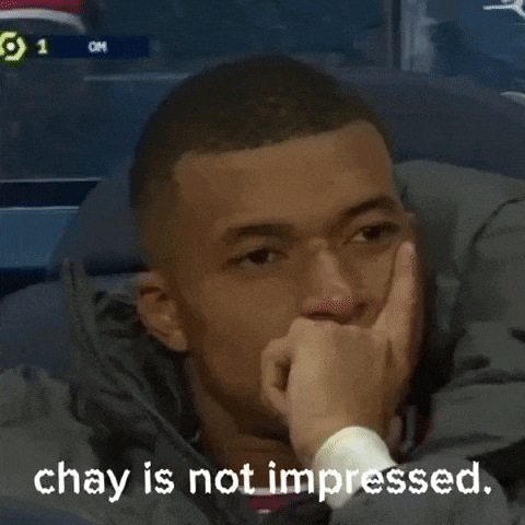 a man is sitting in a chair with his hand on his chin and a caption that says `` chay is not impressed '' .