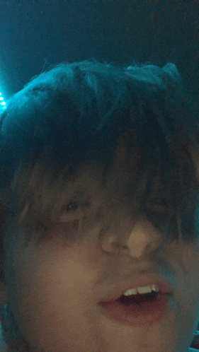 a close up of a person 's face with their mouth open and teeth visible