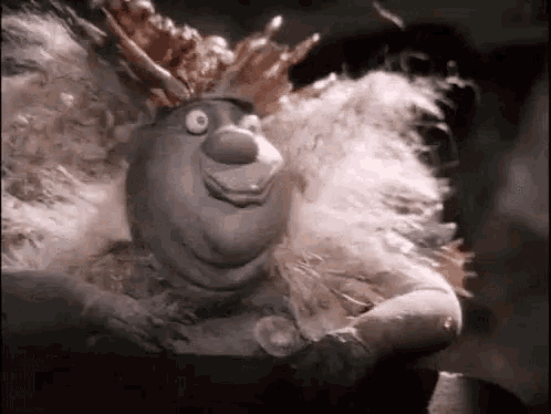 a close up of a cartoon character wearing a crown and a fur coat .