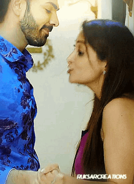 a woman is kissing a man on the cheek with the words ruksarcreations on the bottom right