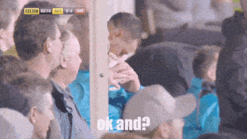 a group of people watching a soccer game with the words ok and on the bottom