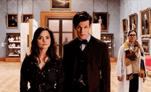 a man and a woman are standing next to each other in a room .