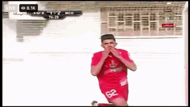a soccer player with the number 62 on his shorts is celebrating