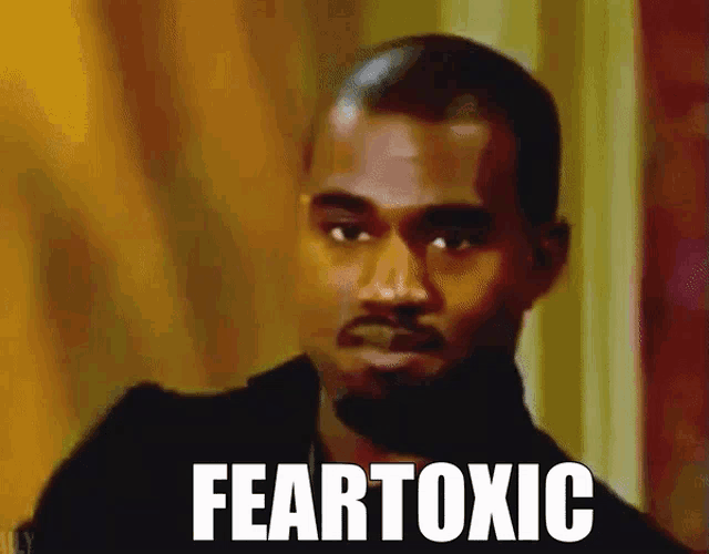 a close up of a man 's face with the words feartoxic written on the bottom