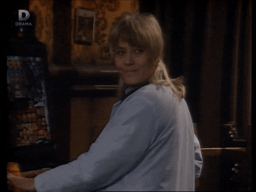 a woman is sitting in front of a television screen that says drama on it