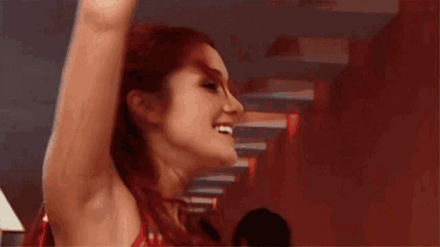 a woman with red hair is smiling and looking up