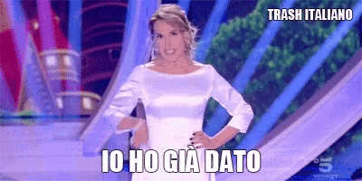 a woman in a white dress is standing with her hands on her hips and says trash italiano