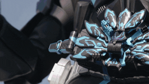 a close up of a black and blue toy with a sword on it