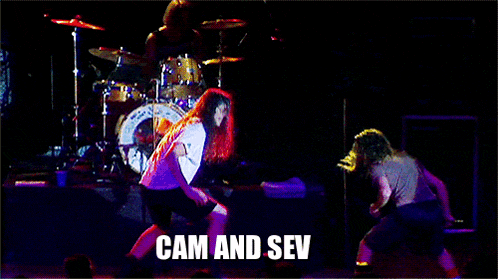 a group of people on a stage with cam and sev written on the bottom