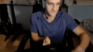a man wearing headphones is sitting in a chair in front of a computer .