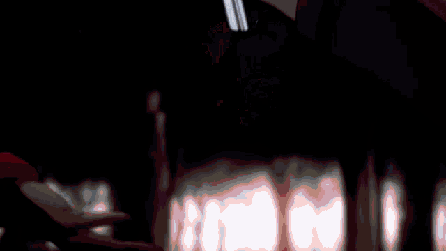 a blurry picture of a person 's hand with a tattoo on it that says ' x '