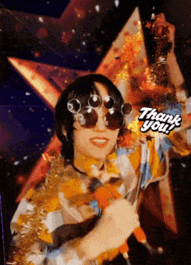 a woman wearing sunglasses and holding a microphone with a thank you sticker on her face