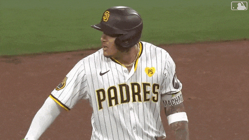 a padres baseball player wearing a helmet and jersey