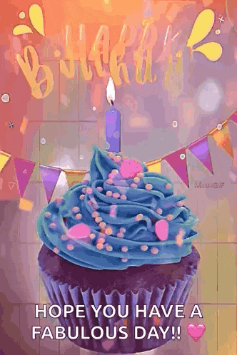 a birthday cupcake with blue frosting and sprinkles and a candle .