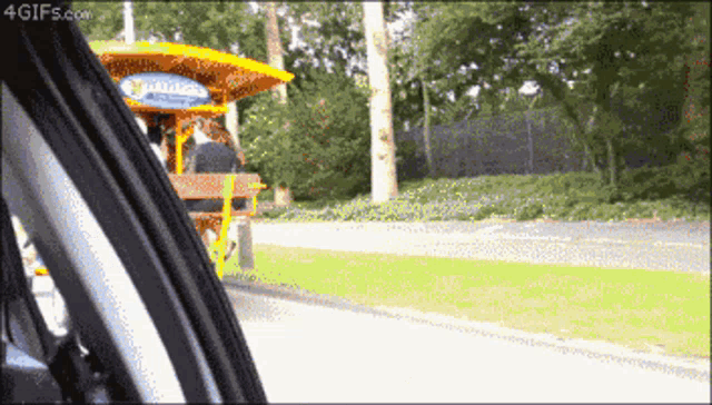 a gif from 4gifs.com shows a horse drawn carriage on a road