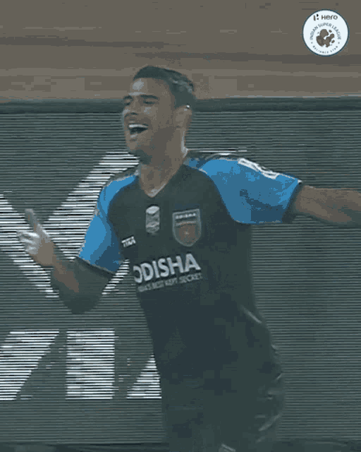 a soccer player wearing a jersey that says ' odisha ' on it
