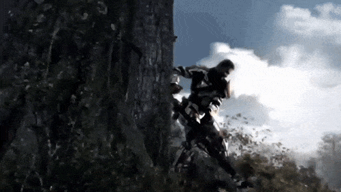 a man is standing next to a tree with a chainsaw