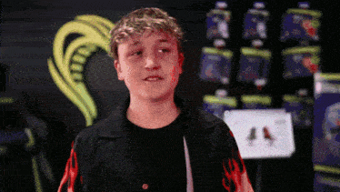 a boy in a black shirt with flames on it