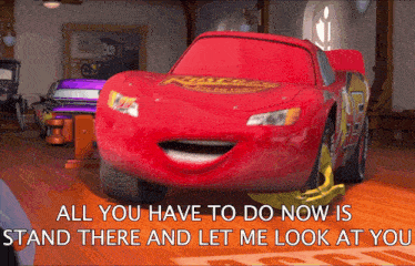a red lightning mcqueen from the movie cars is smiling and says all you have to do now is stand there and let me look at you