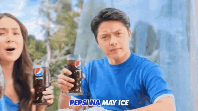 a man and a woman are holding pepsi bottles in their hands