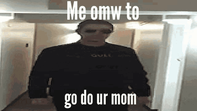 a man is standing in a hallway with the words `` me omw to go do ur mom ''