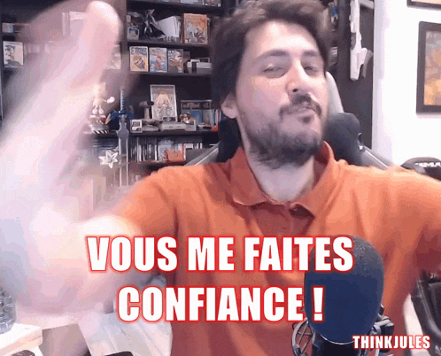 a man with a beard says vous me faites confiance in front of a microphone
